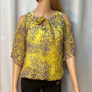 Sheer top with fun detail in eye catching print. M